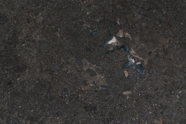Floor repaired with DiamaKrete Mortarand colored with Dye. Shiny metal are the remains of conduits in the Floor